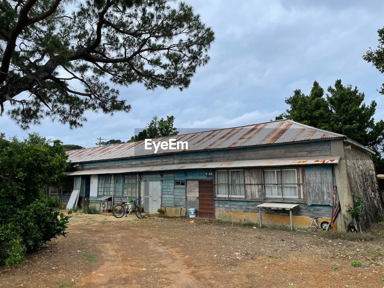 architecture, built structure, building exterior, rural area, tree, building, plant, home, house, sky, nature, shack, farm, cloud, no people, estate, residential area, rural scene, landscape, residential district, day, outdoors, cottage, real estate, wood, roof, hut