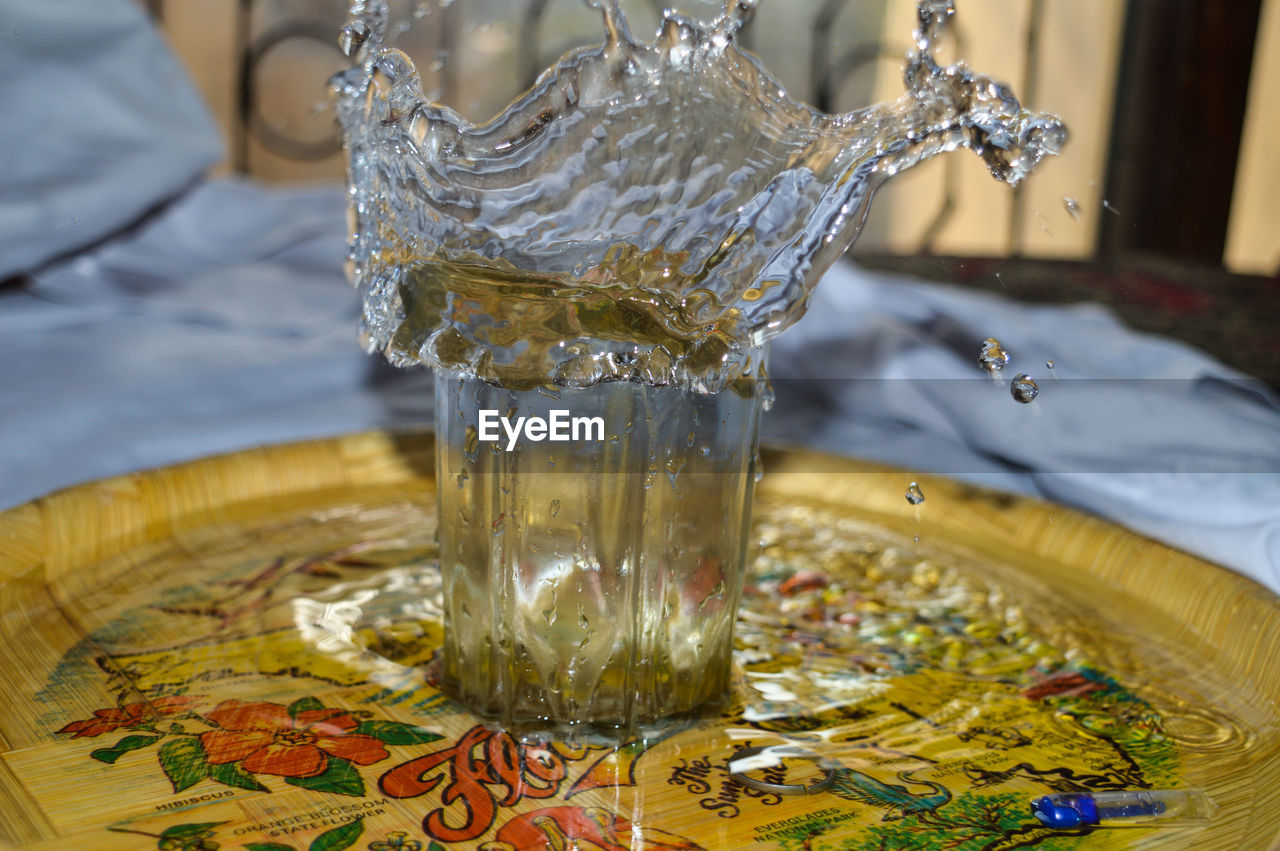 Close-up of water splashing in glass on table