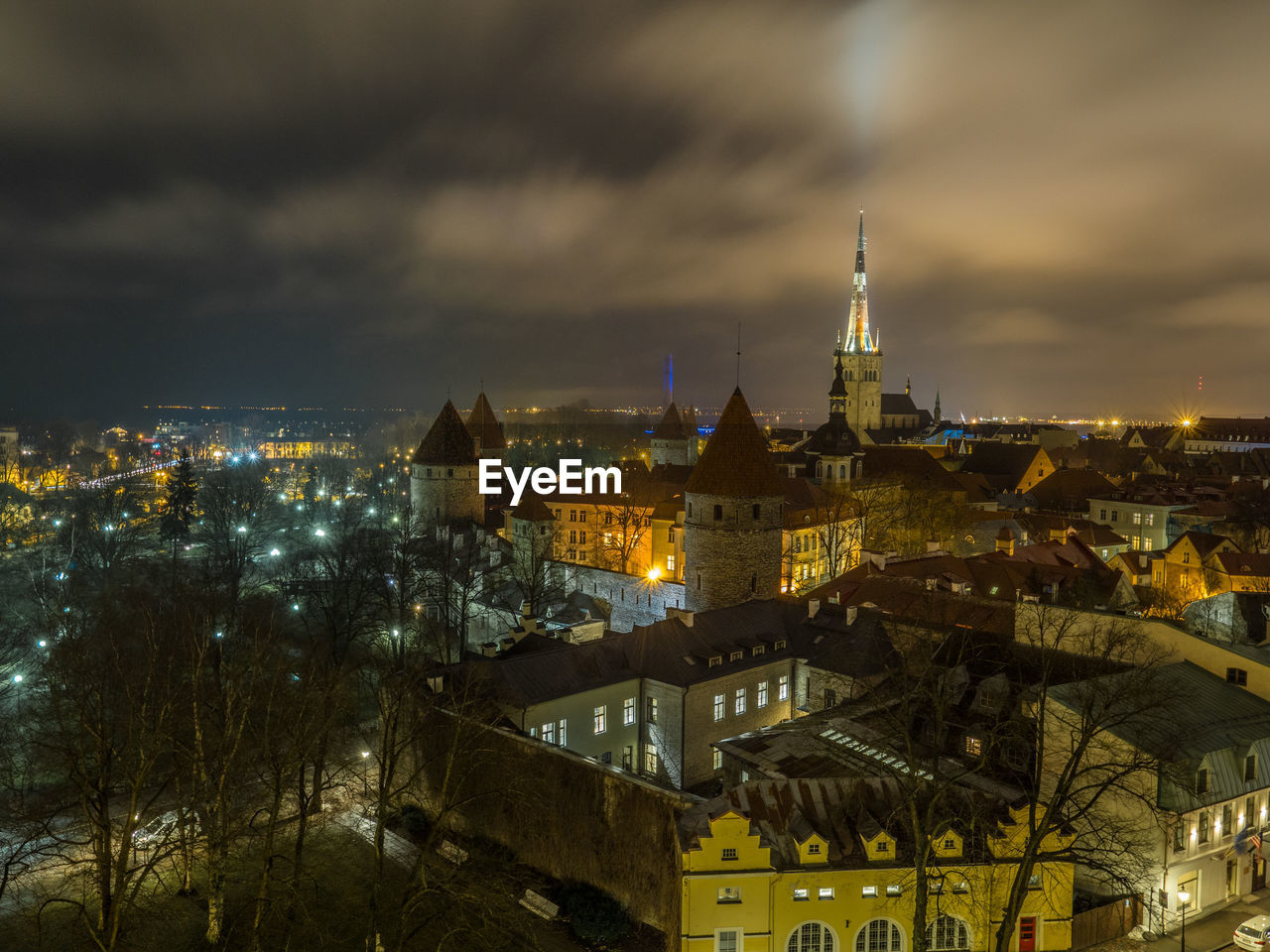 Illuminated cityscape against sky at night