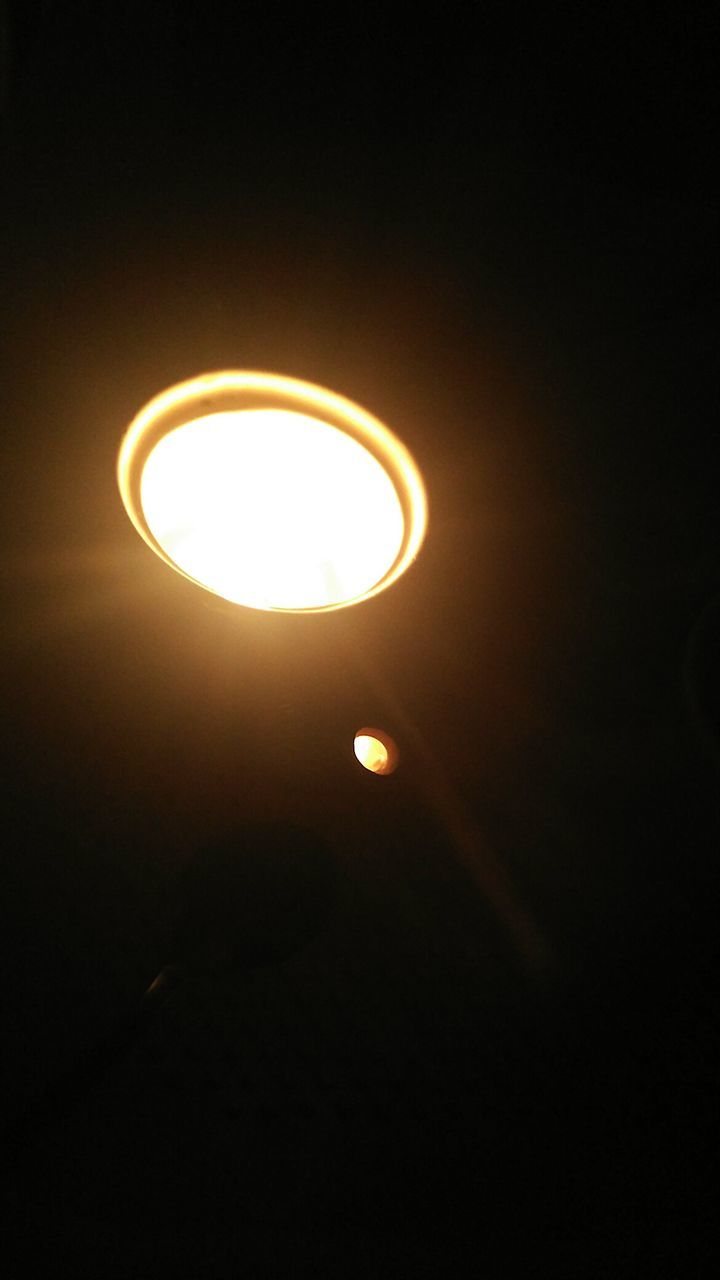 LOW ANGLE VIEW OF ILLUMINATED LAMP POST