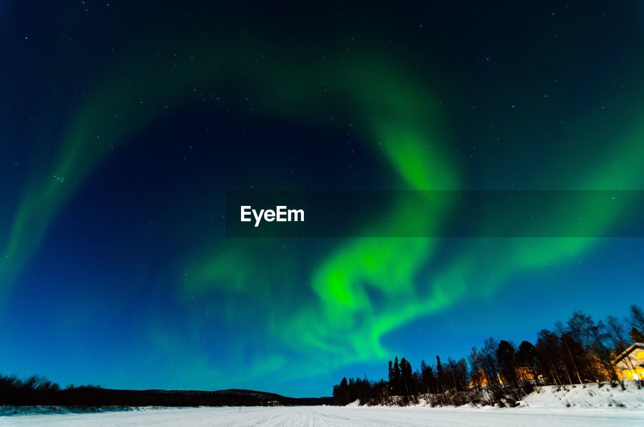 Scenic view of snowy landscape against sky at night