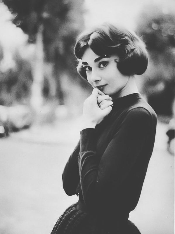 PORTRAIT OF YOUNG WOMAN STANDING ON RAILING