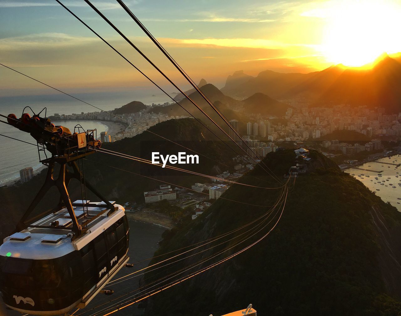 Overhead cable car against mountains during sunset