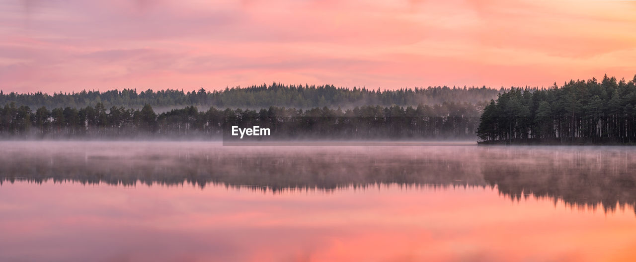 Scenic view of lake against sky at sunset