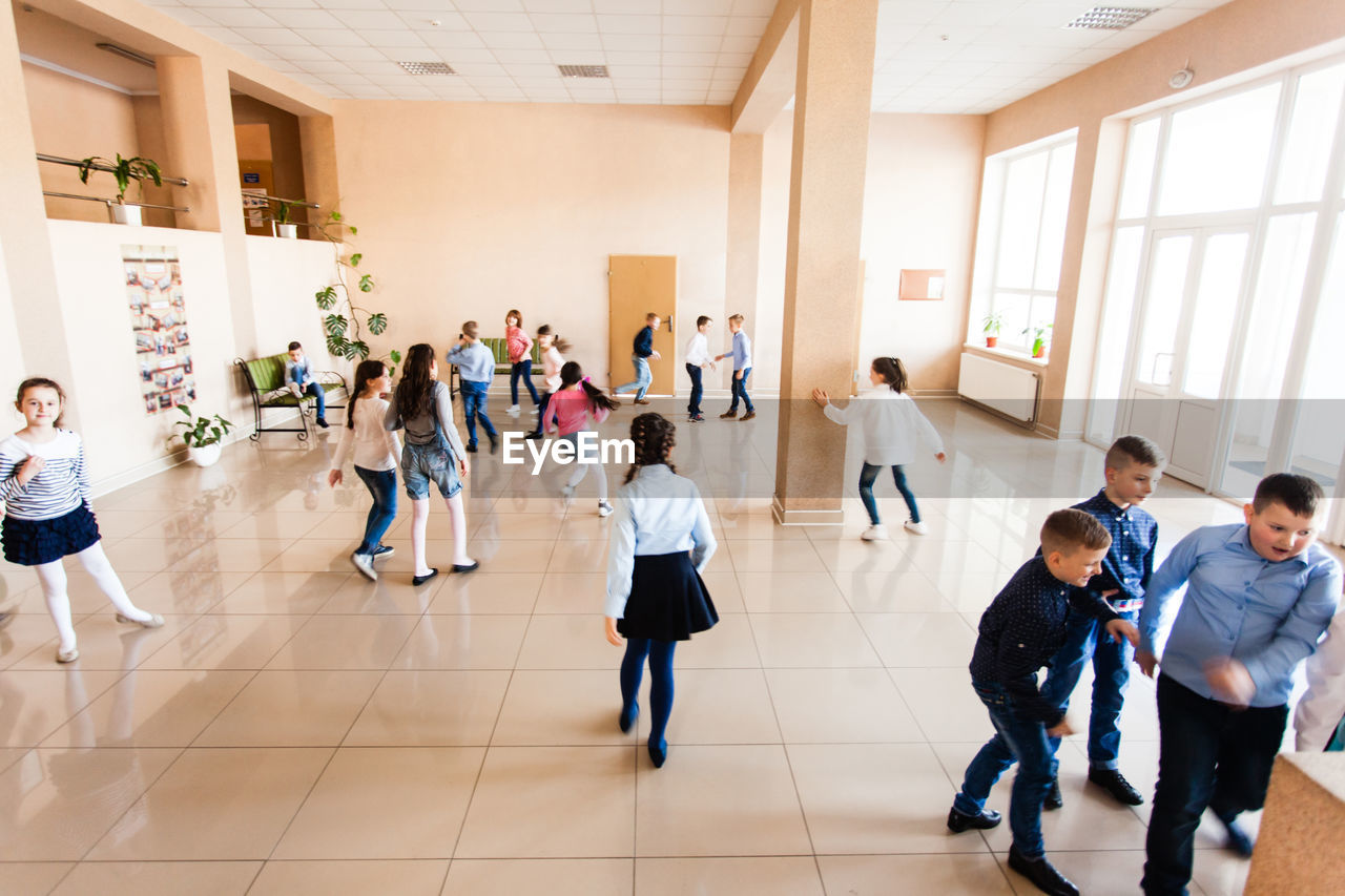 Group of people standing on tiled floor