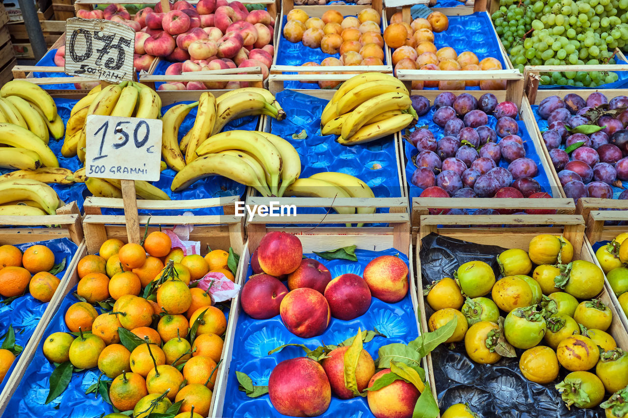 Fresh fruits in wooden boxes for sale at a market