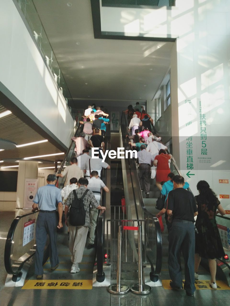 GROUP OF PEOPLE STANDING IN ILLUMINATED STORE