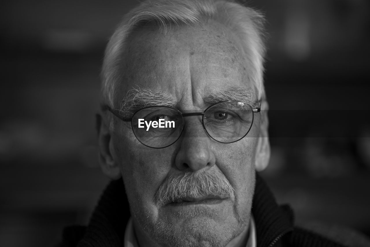 Close-up portrait of man wearing eyeglasses