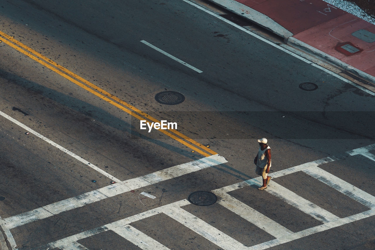 High angle view of man walking on a crossroad in miami