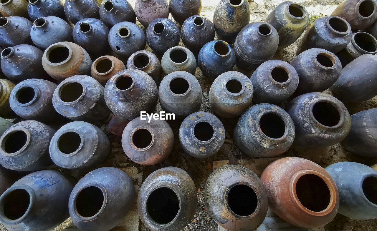 FULL FRAME SHOT OF STACK OF PIPES