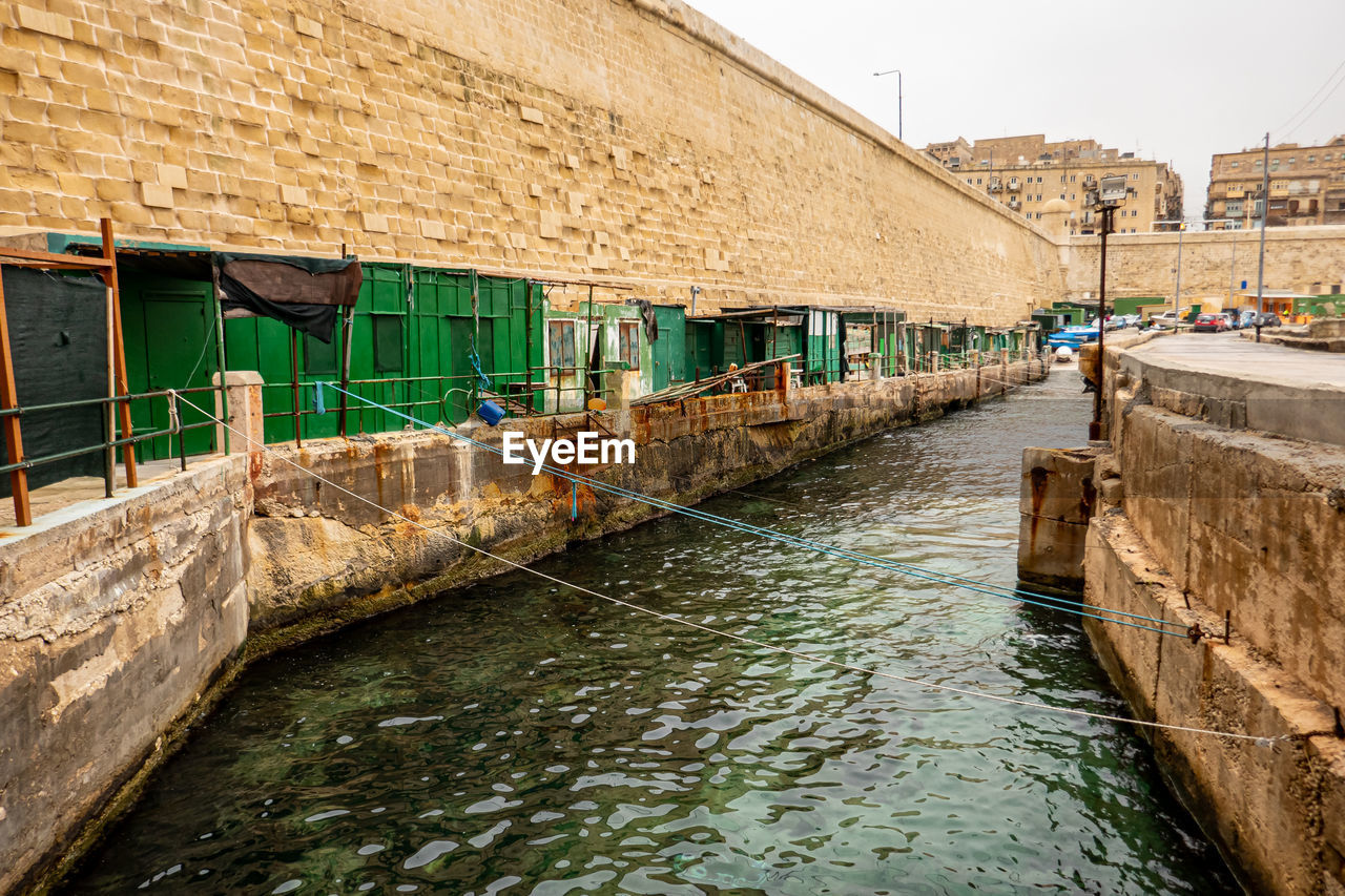 Valletta, malta. ancient fishermen's houses and warehouses at the canal