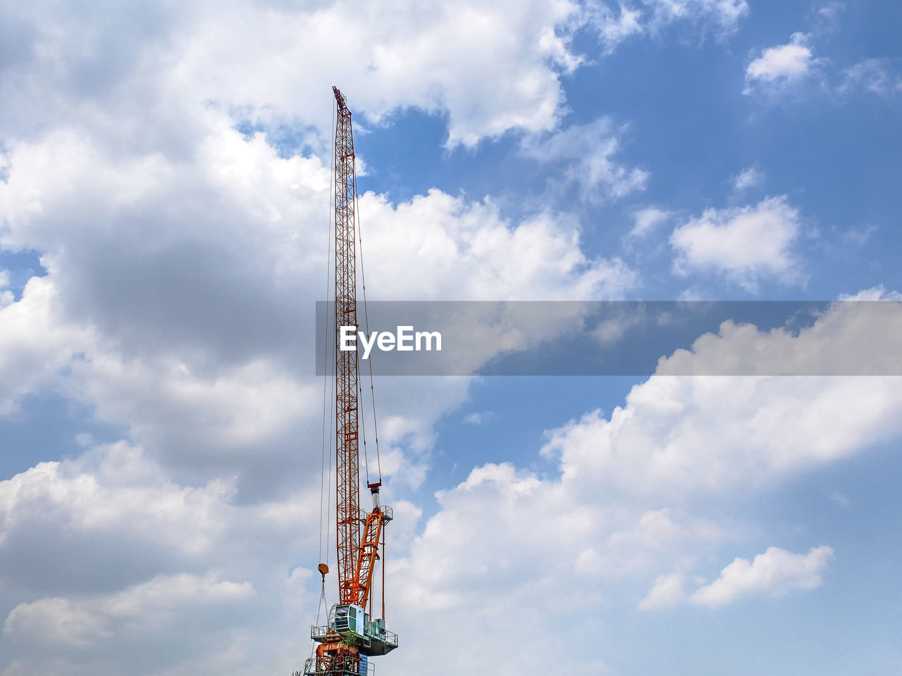 Low angle view of crane against sky