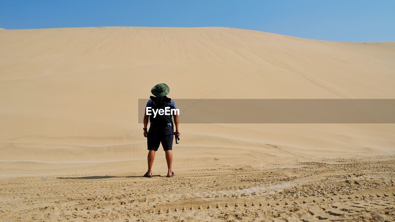 Rear view full length of man standing at desert