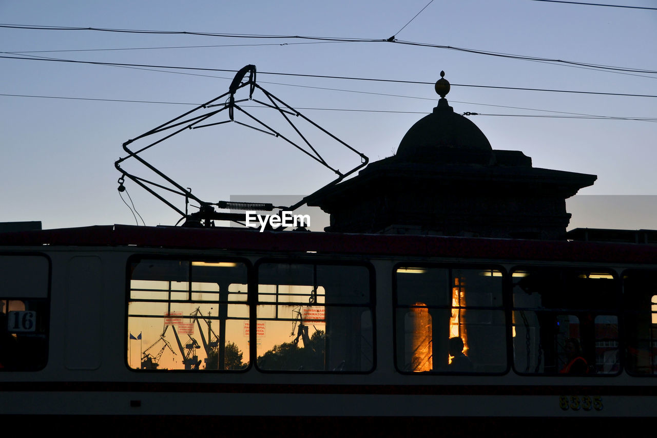 Tram on staro-kalinkin bridge during sunset