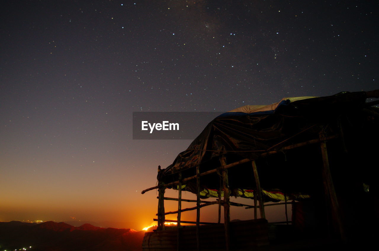 Silhouette built structure against sky at night