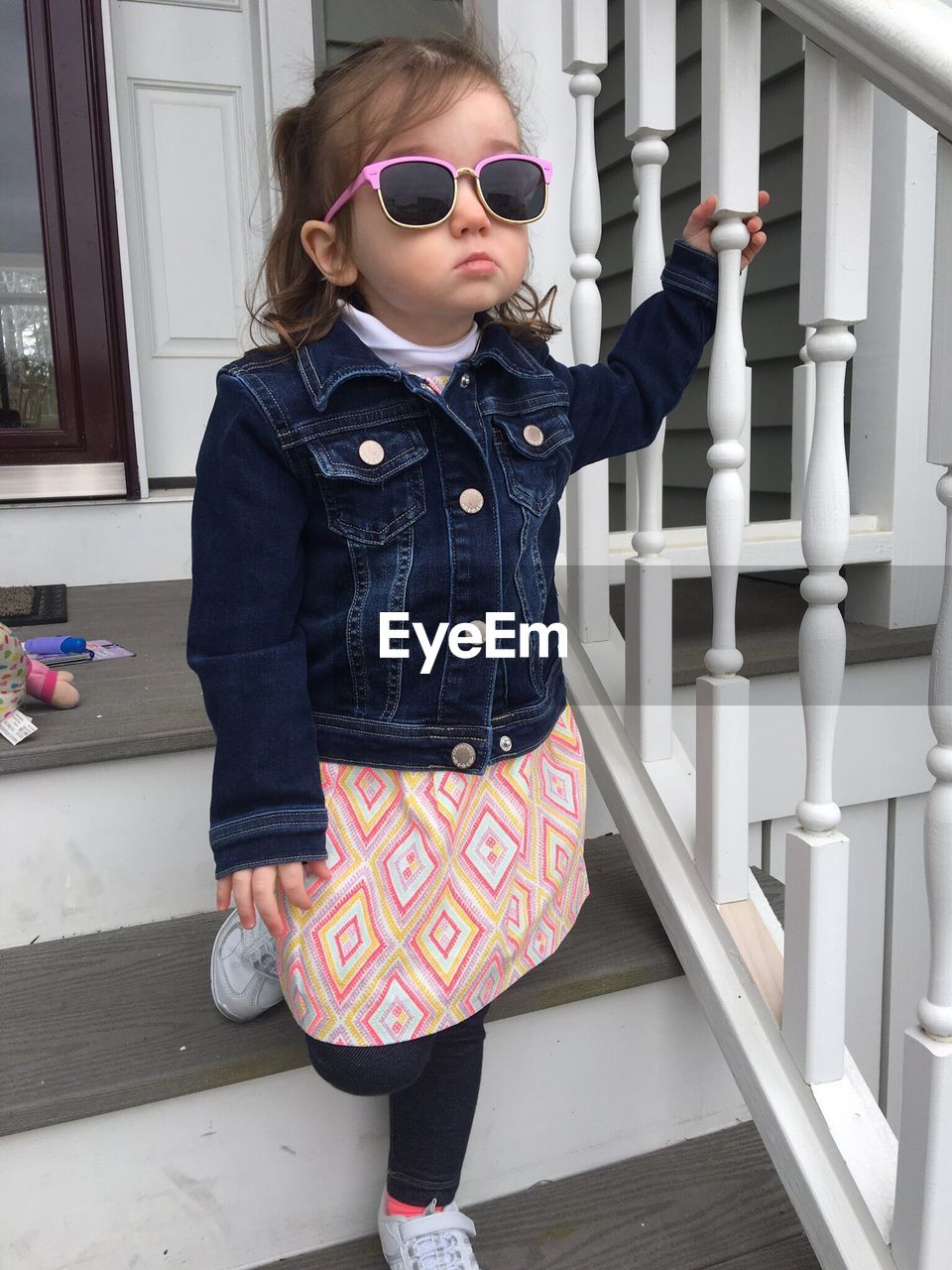 Girl wearing sunglasses standing on steps