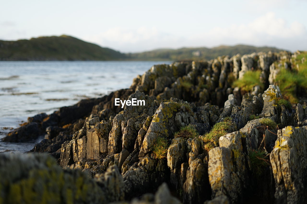 Rocks on beach against sky