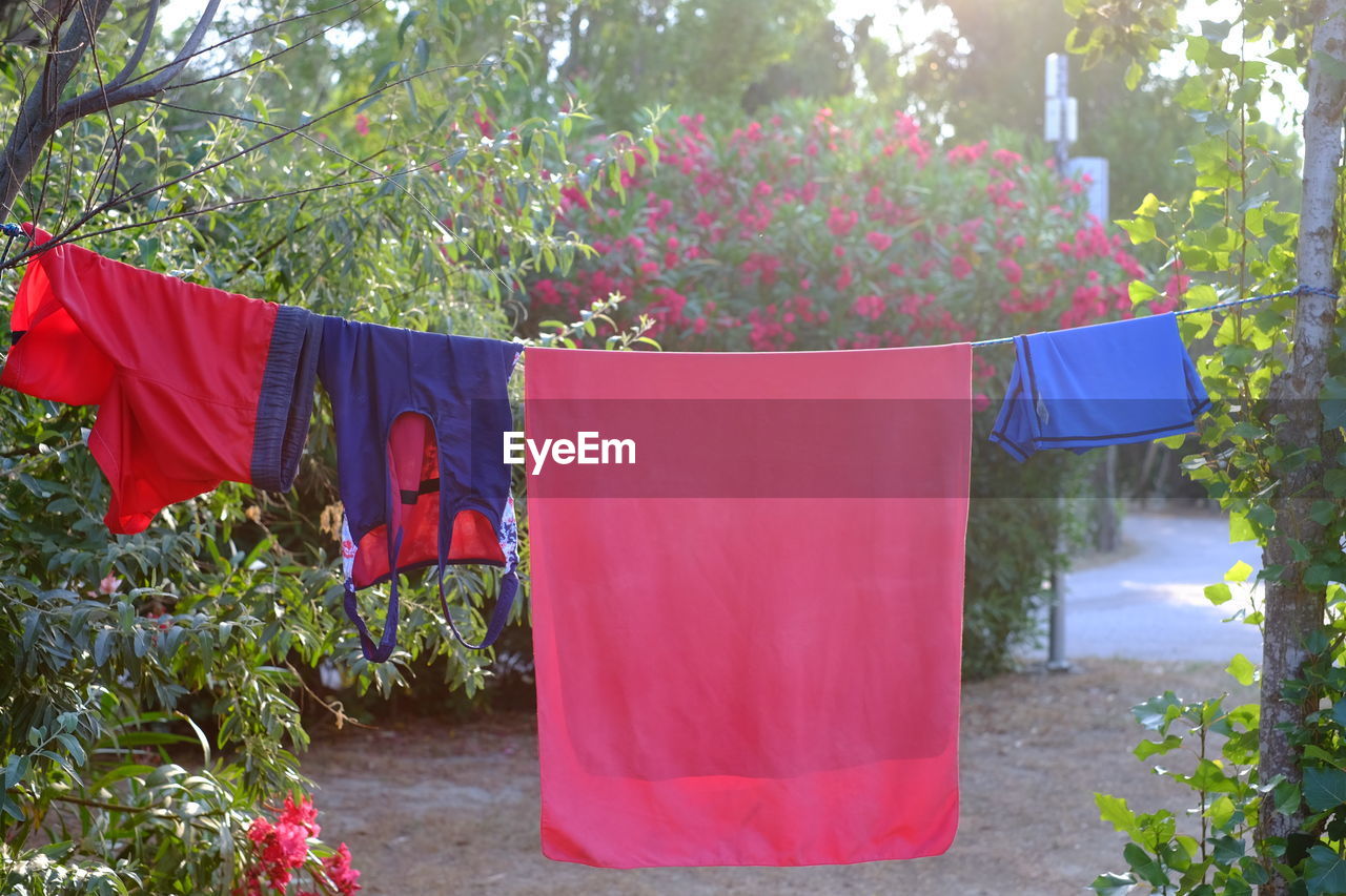 RED CLOTHES DRYING ON CLOTHESLINE