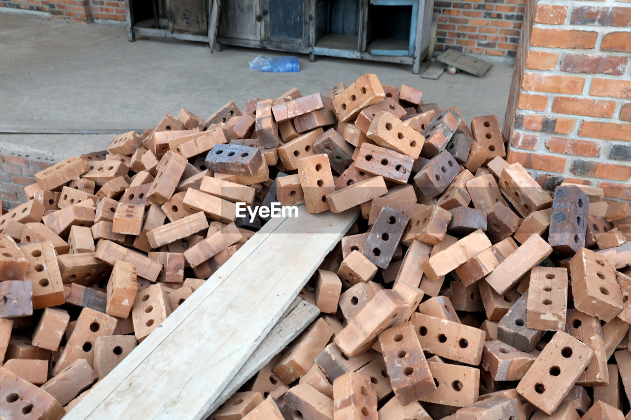 wood, brick, large group of objects, abundance, wall, timber, no people, industry, architecture, day, brickwork, lumber, iron, heap, log, outdoors, construction industry, high angle view