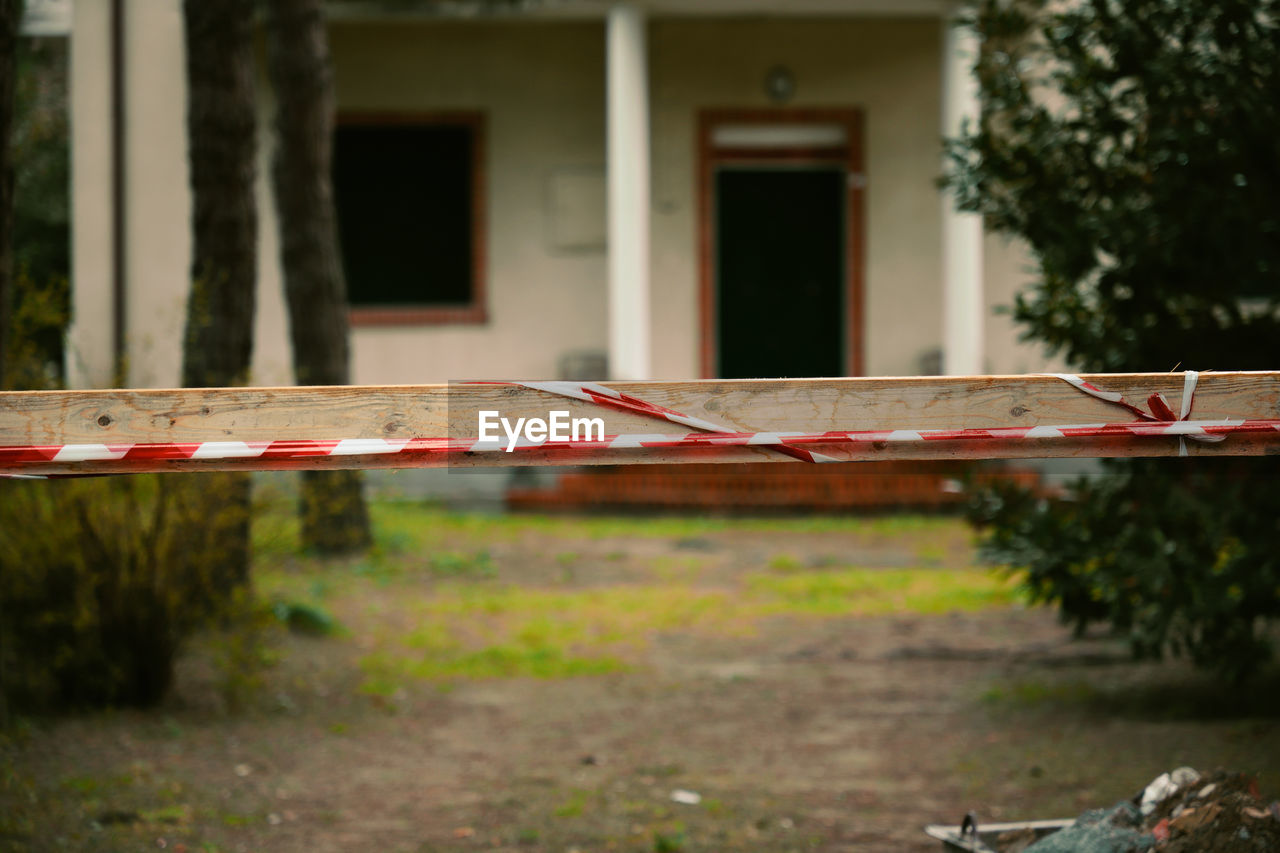 Construction Construction Site Absence Architecture Building Building Exterior Building Site Built Structure Construction Industry Day Empty Focus On Foreground Front Or Back Yard Grass Growth Nature No People Outdoors Plant Selective Focus Tape Transportation Tree Warning Window 17.62°