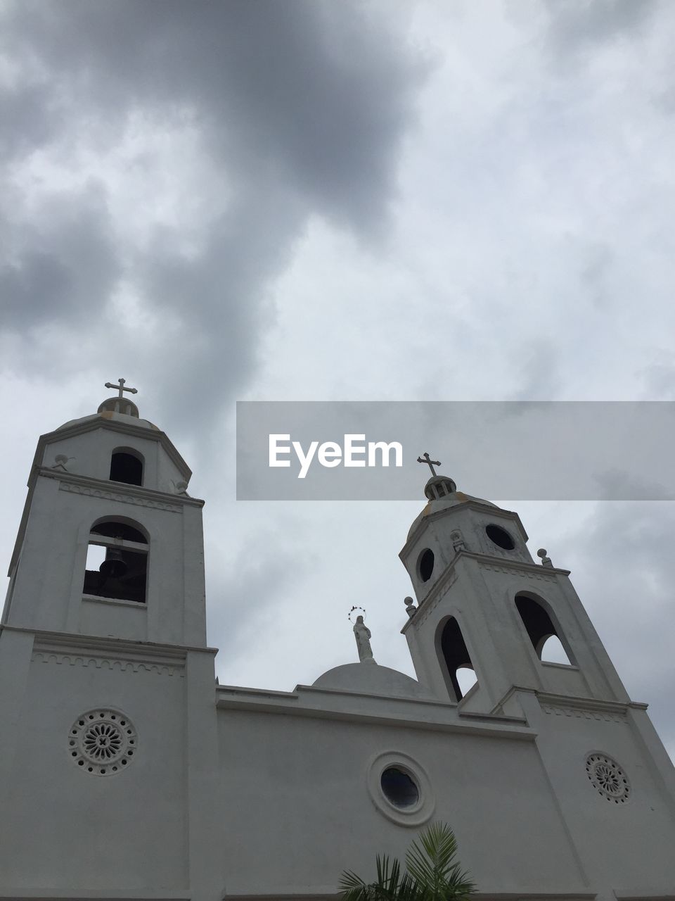 LOW ANGLE VIEW OF BUILDINGS AGAINST CLOUDY SKY