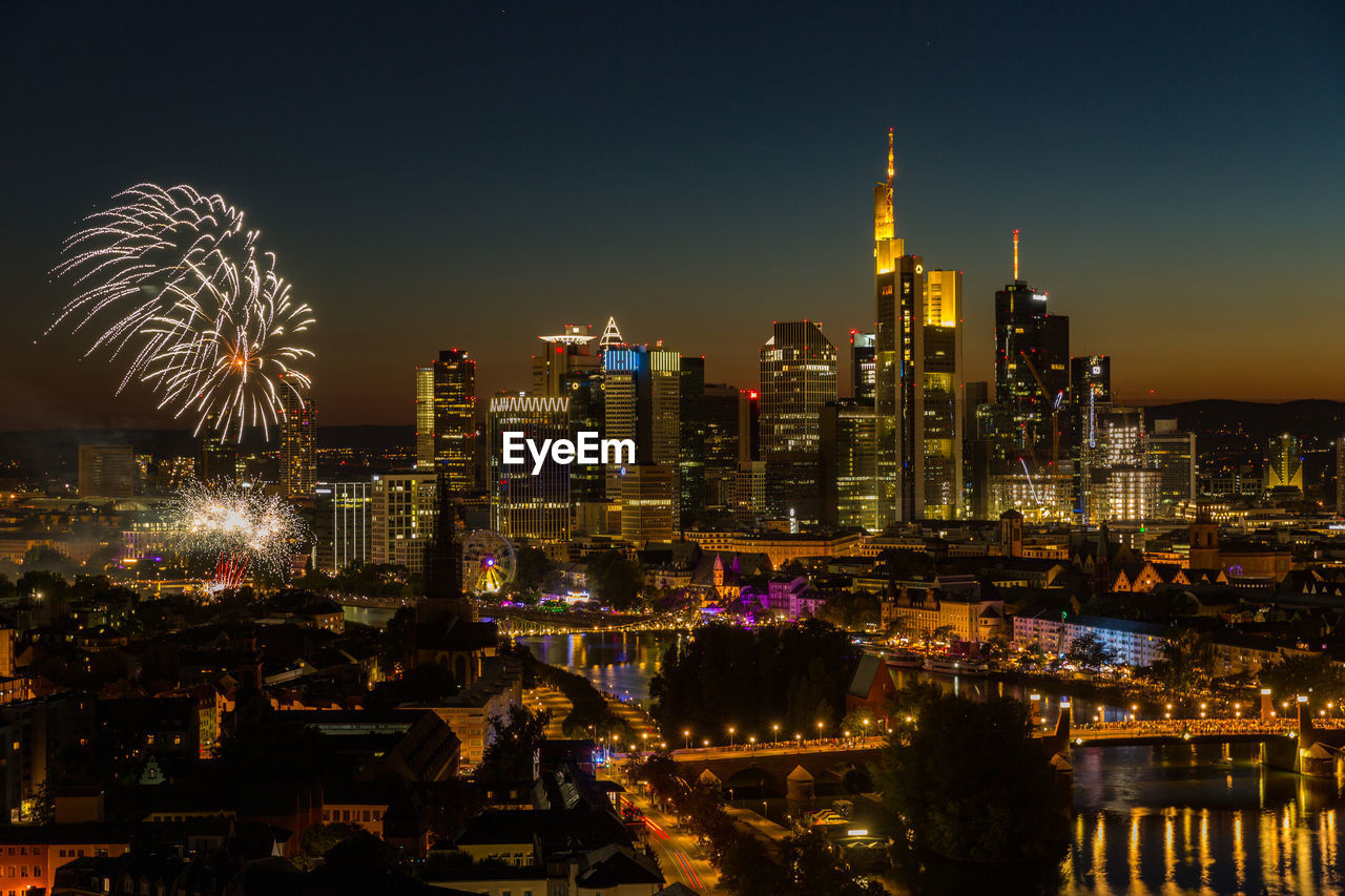 Fireworks mainfest frankfurt in front of illuminated city skyline