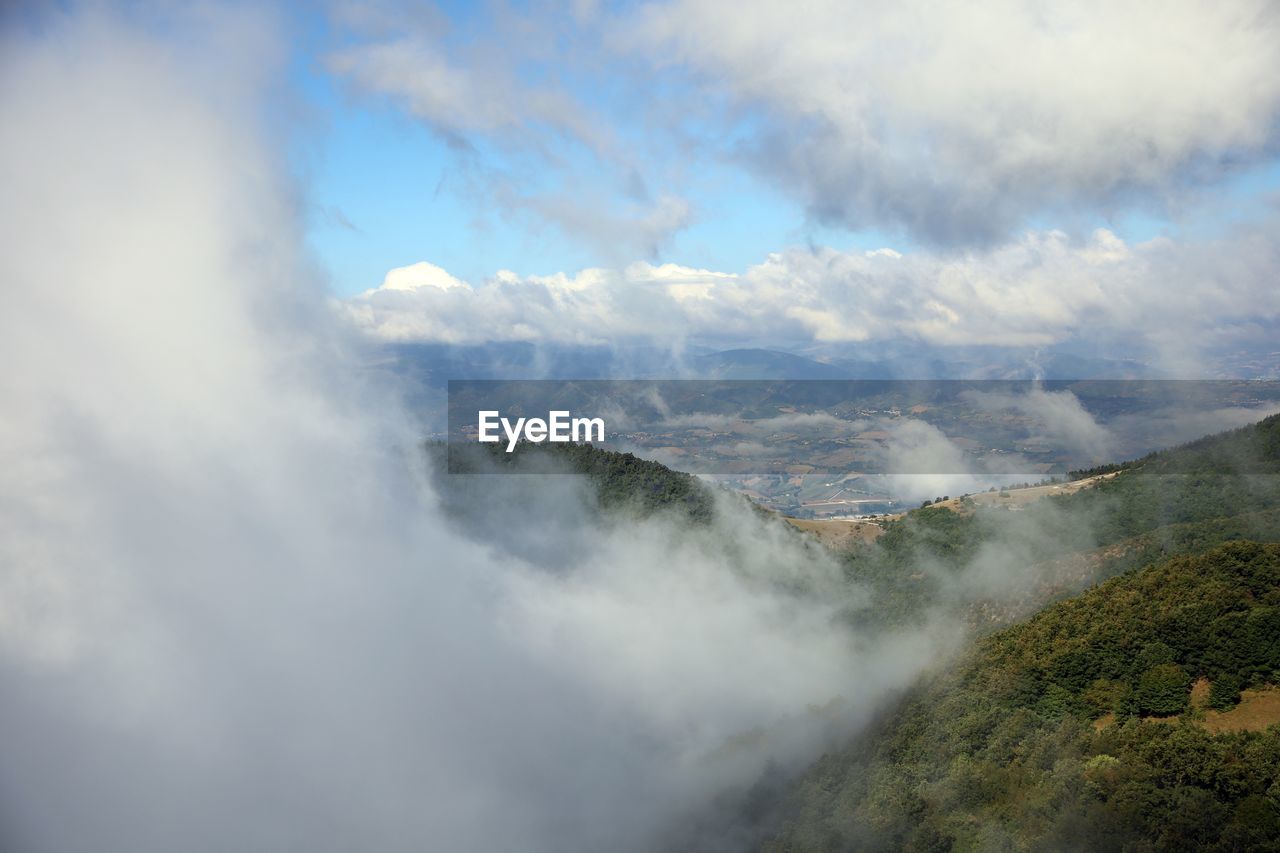 Aerial view of clouds over mountain