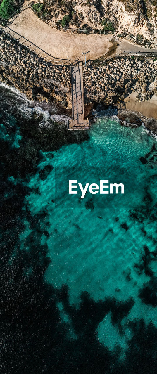 HIGH ANGLE VIEW OF SWIMMING POOL AT SEA
