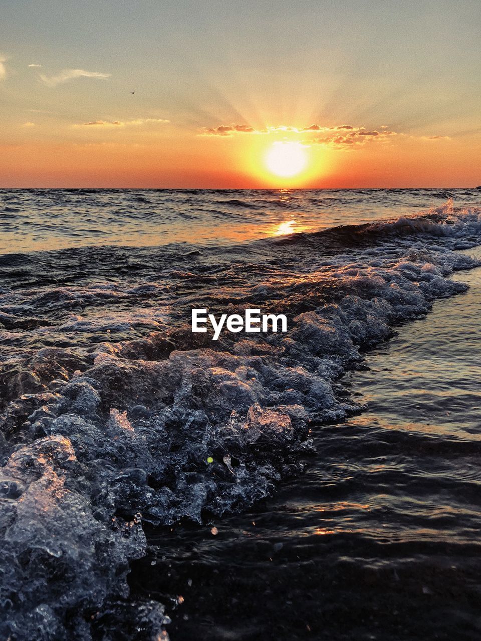 SCENIC VIEW OF BEACH DURING SUNSET