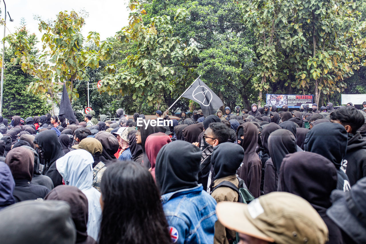 REAR VIEW OF PEOPLE ON STREET