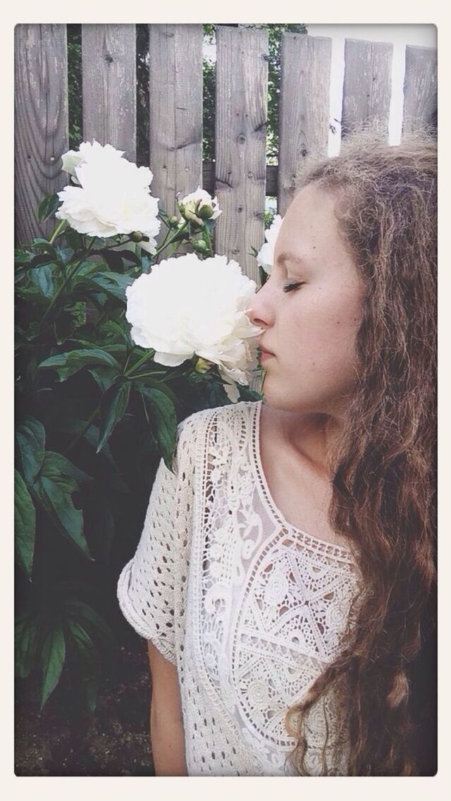 Girl smelling flowers