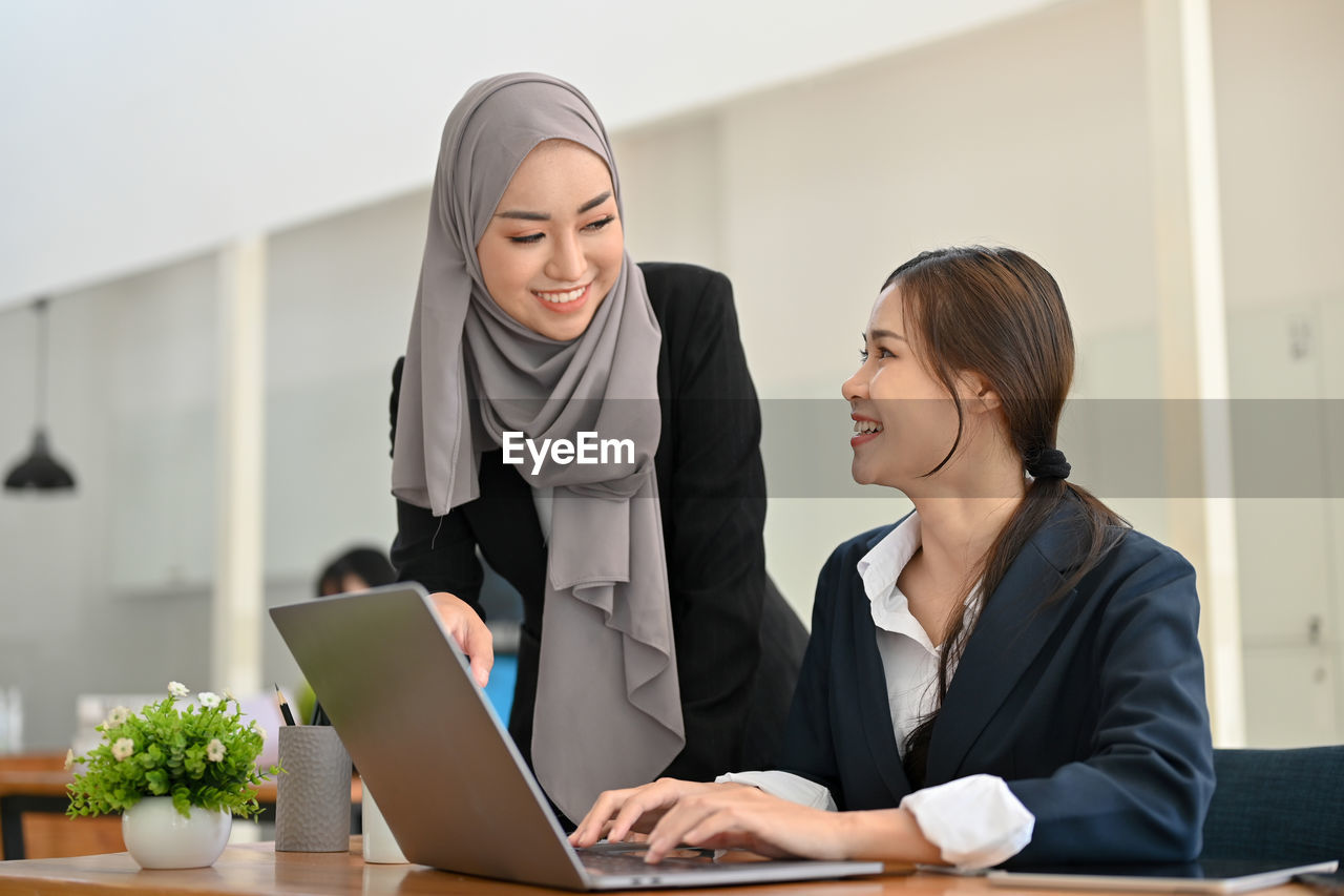 young woman using laptop while sitting at home