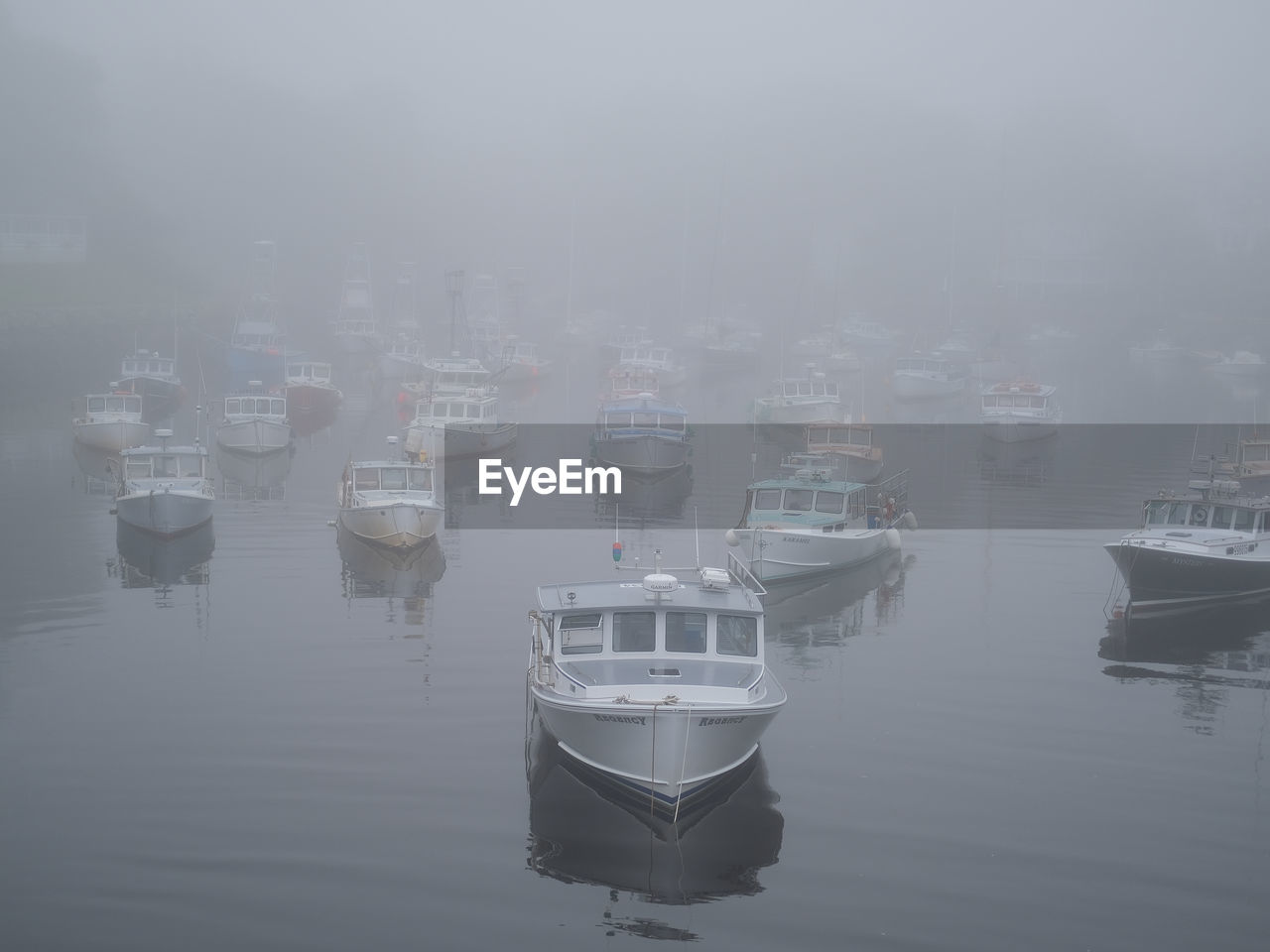 fog, water, nautical vessel, ship, transportation, reflection, mode of transportation, nature, no people, sea, moored, waterfront, vehicle, tranquility, day, boat, mist, outdoors, architecture, watercraft, sky, harbor, beauty in nature, building exterior