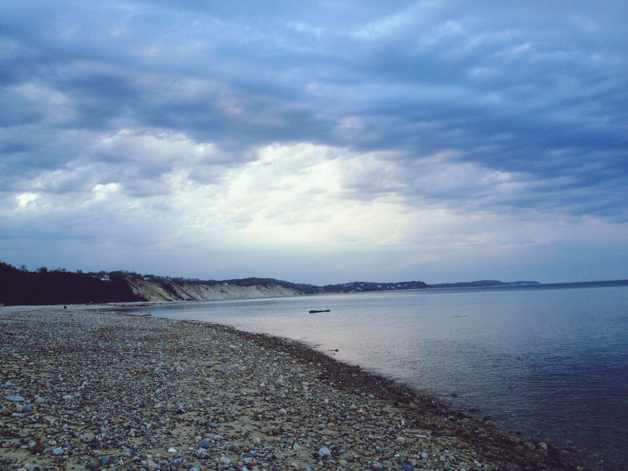 Scenic view of sea and beach against cloudy sky