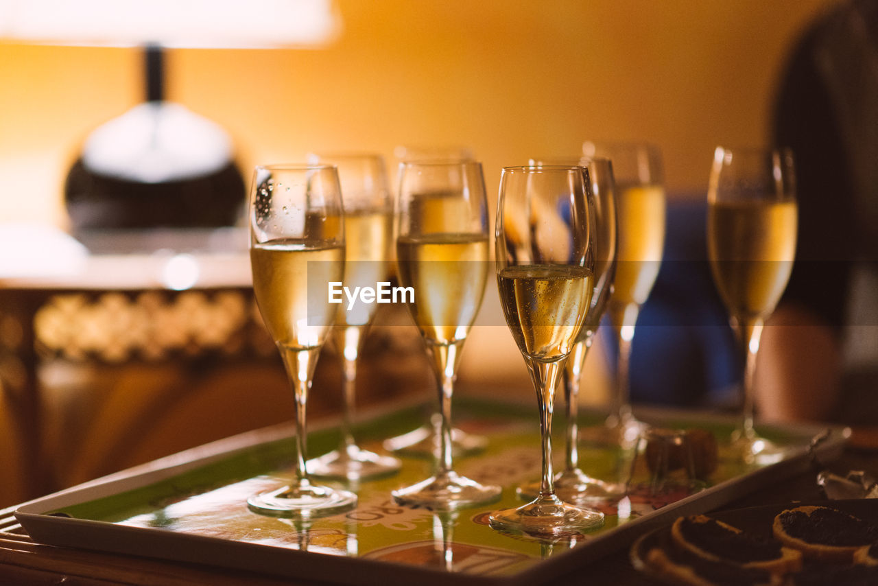 Close-up of champagne flutes on tray