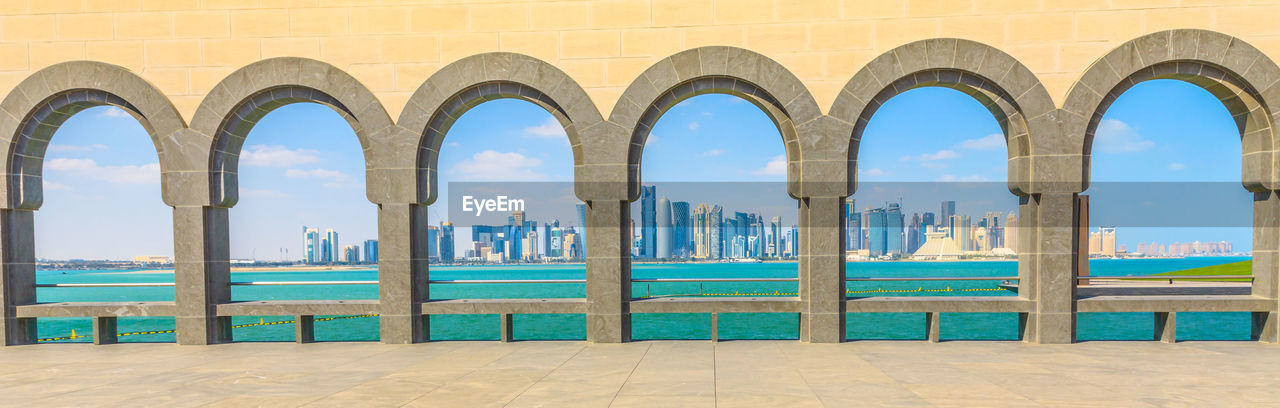 Cityscape and sea seen through arch