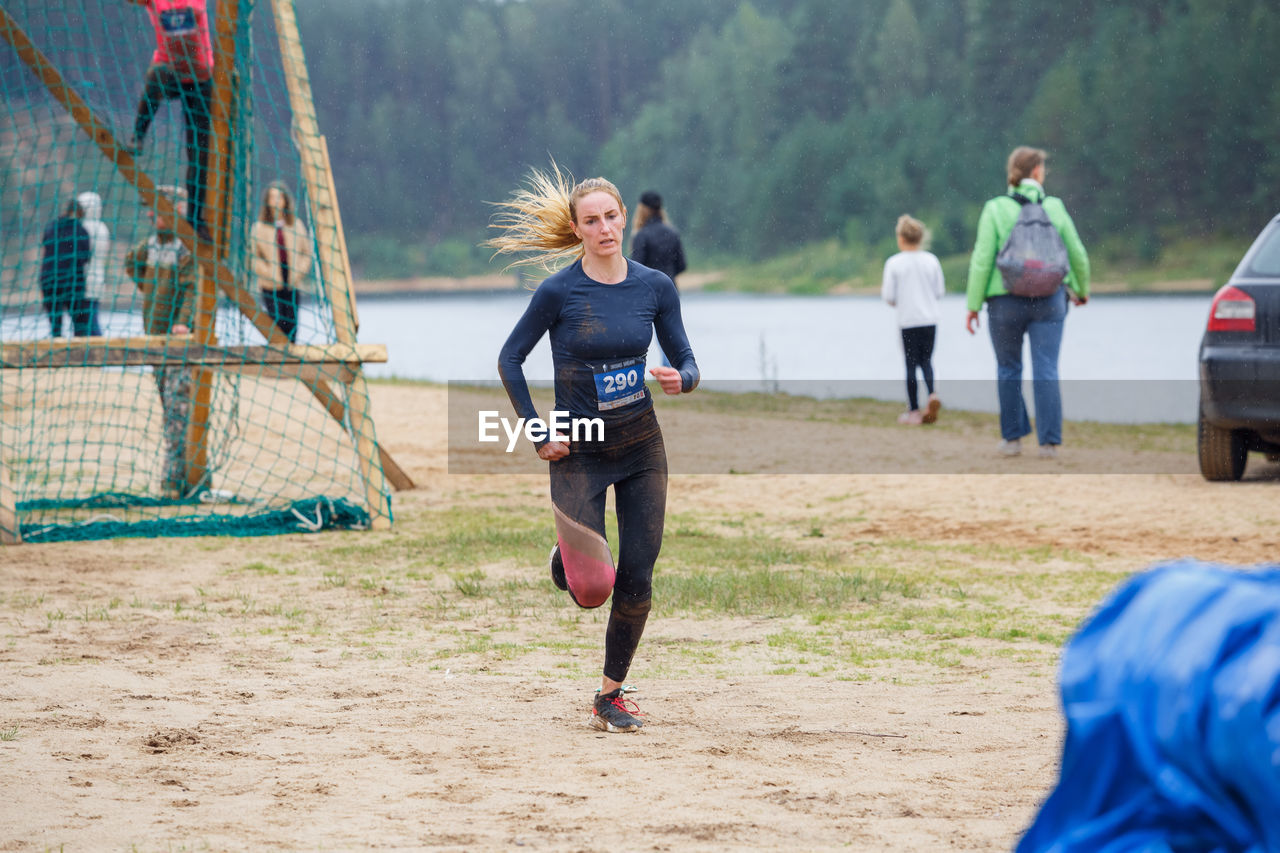 FULL LENGTH OF WOMAN RUNNING ON LAND