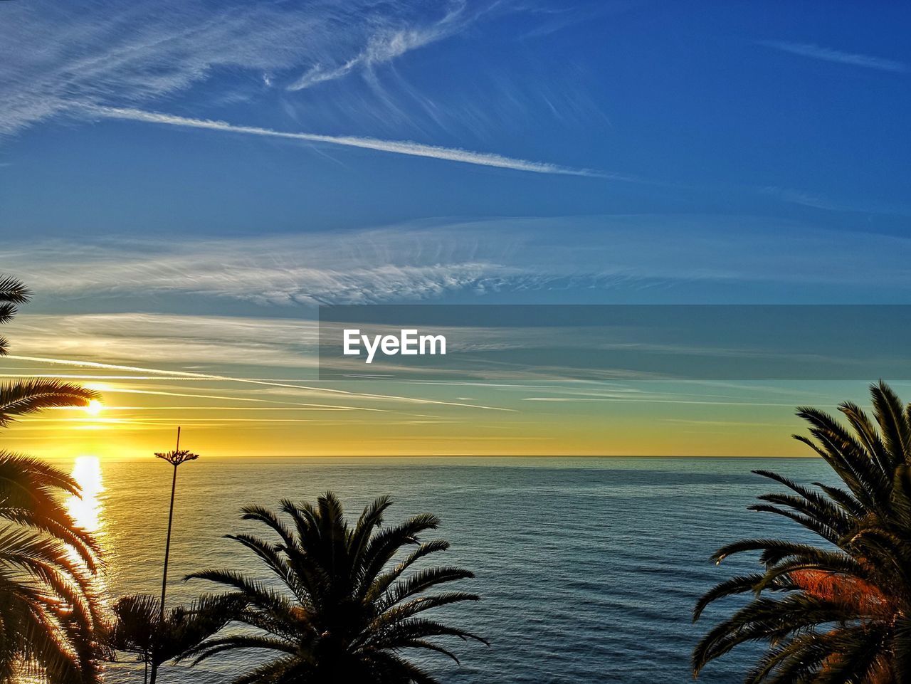 Scenic view of sea against sky at sunset