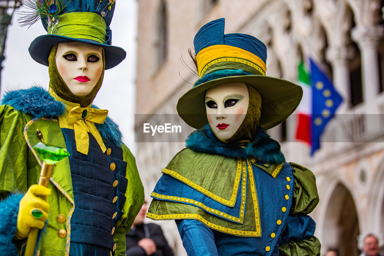 Man and woman in costume during venice carnival