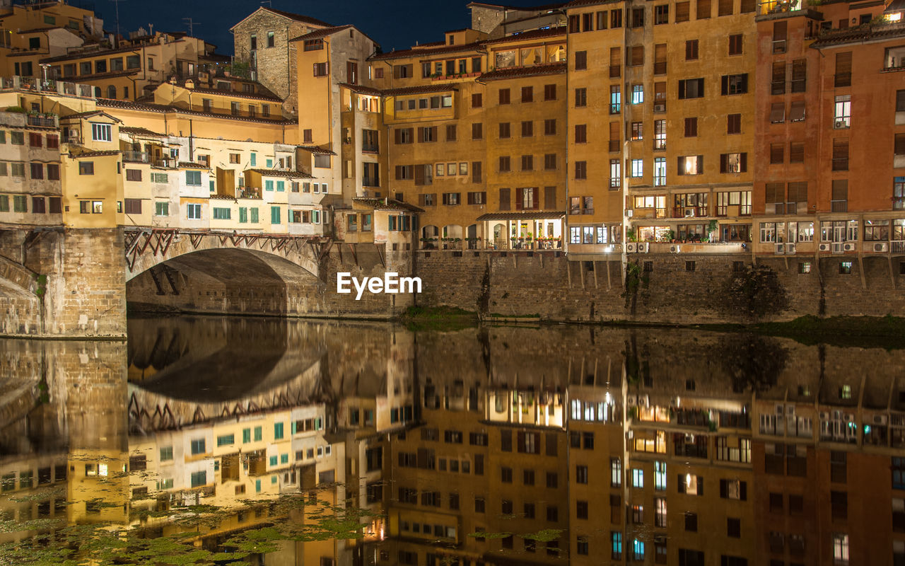 Reflection of buildings in city at night