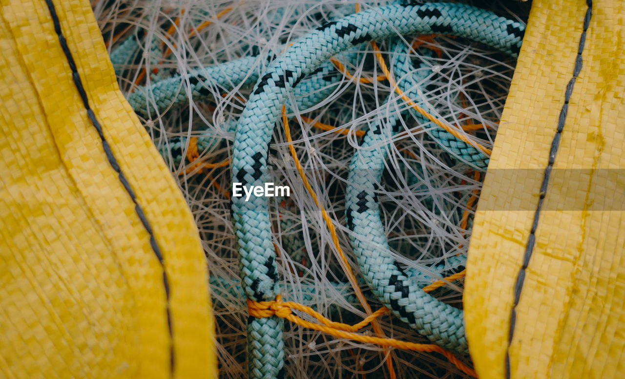 Bundles of fishing nets inside a plastic tarpaulin