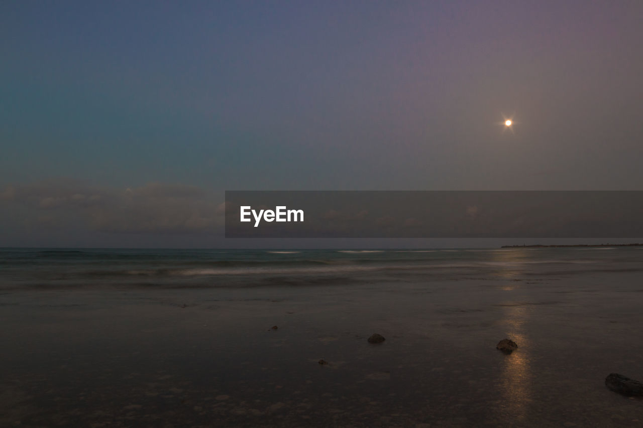 SCENIC VIEW OF SEA AGAINST MOON AT NIGHT