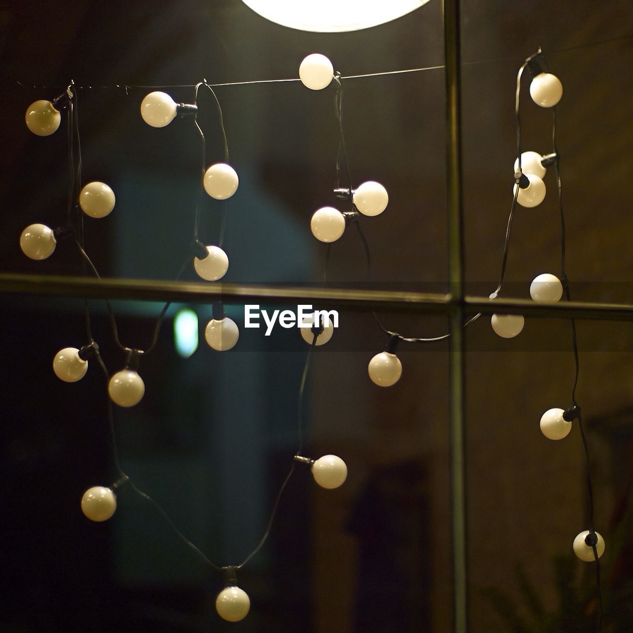 Light bulbs hanging on metal window