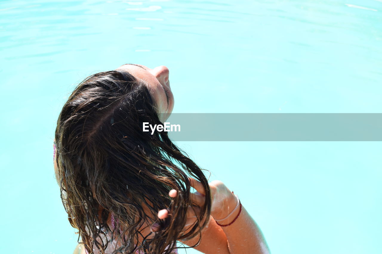 Rear view of teenage girl in pool