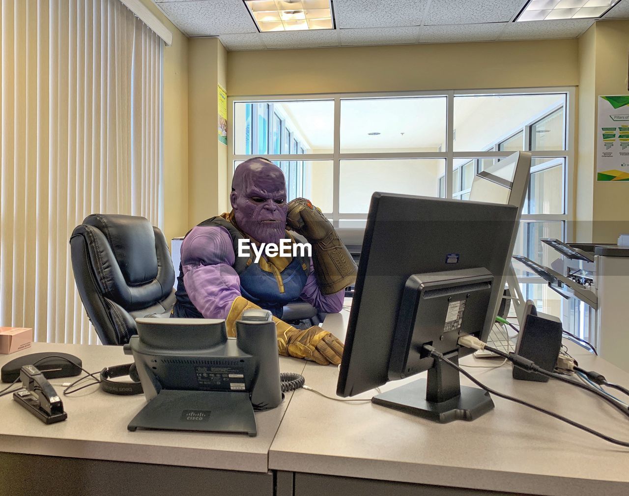 MAN WORKING ON TABLE IN OFFICE