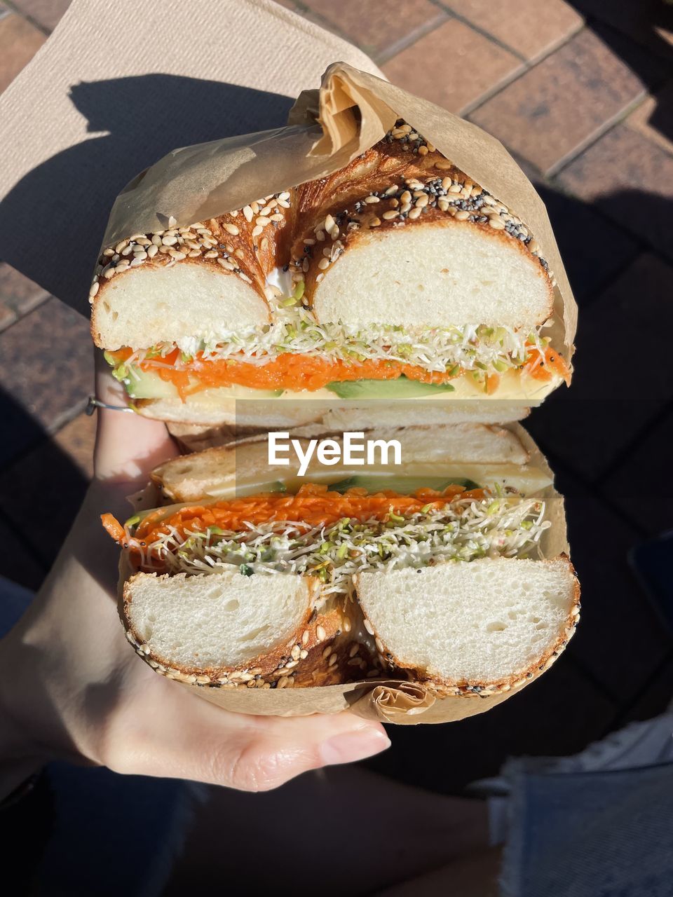 Close-up of hand holding bagel