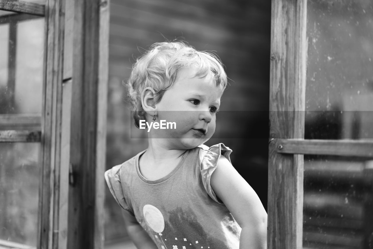 PORTRAIT OF CUTE BOY LOOKING THROUGH CAMERA