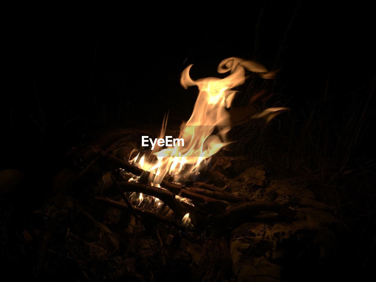 High angle view of camp fire on field at night