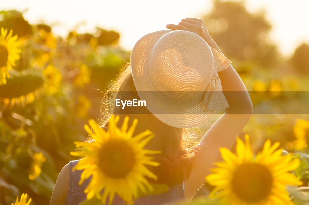 Young woman in sunflower farm