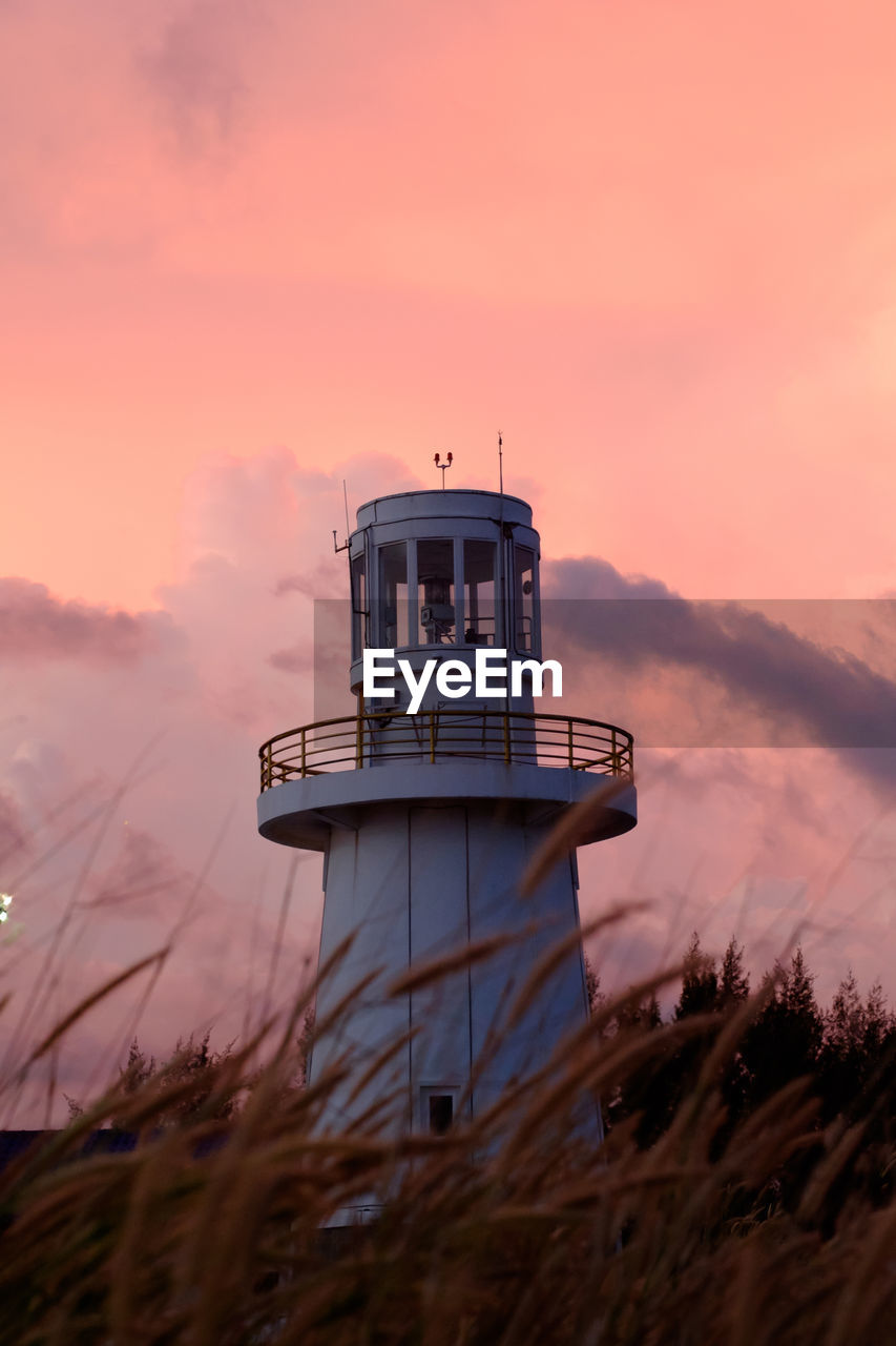 Lighthouse against sky during sunset